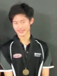 Oliver wearing a medal after a badminton tournament